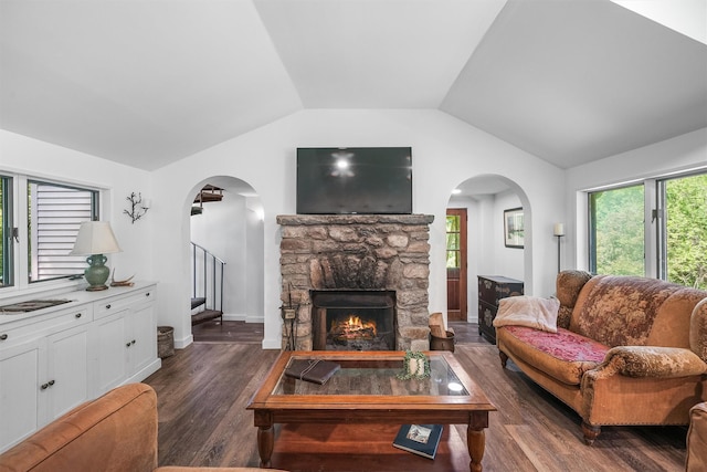 42 Raspberry Ln, Carmel, NY 10512 - living area featuring arched walkways, lofted ceiling, stairs, dark wood-type flooring, and a stone fireplace