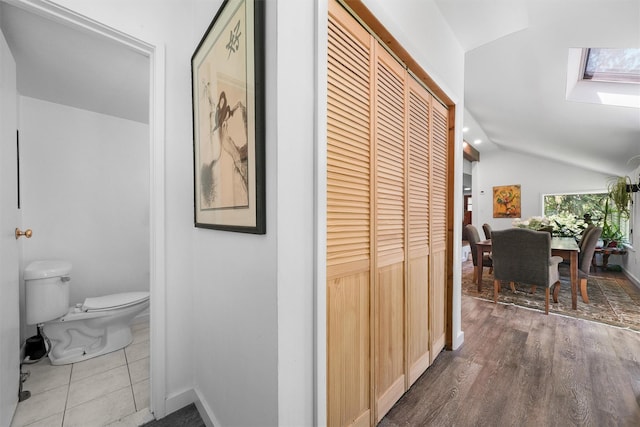 42 Raspberry Ln, Carmel, NY 10512 - hall featuring lofted ceiling, a skylight, baseboards, and wood finished floors
