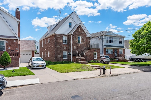 157-27 99th St, Howard Beach, NY 11414 - view of front of home with concrete driveway, brick siding, a front yard, and an attached garage