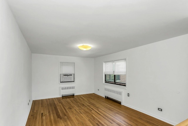 219-36 75th Ave Unit 243A2, Bayside, NY 11364 - empty room with radiator heating unit, wood finished floors, and baseboards