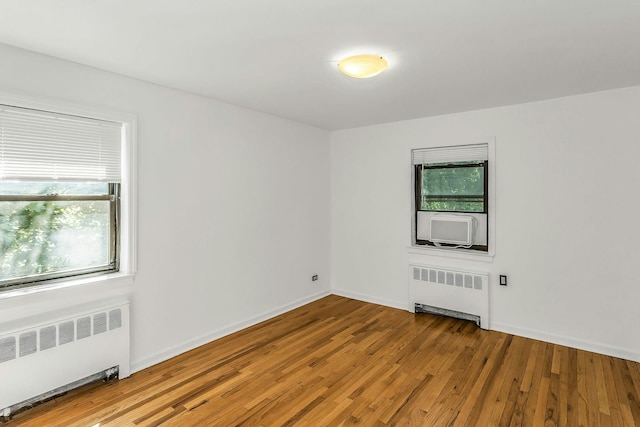 219-36 75th Ave Unit 243A2, Bayside, NY 11364 - empty room with radiator heating unit, wood finished floors, and baseboards
