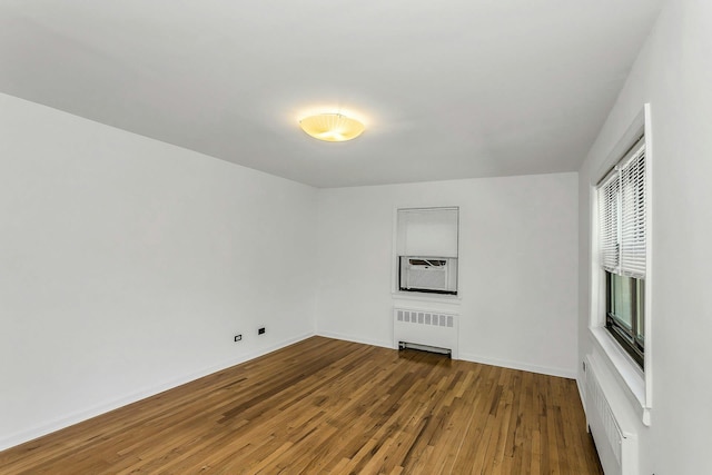 219-36 75th Ave Unit 243A2, Bayside, NY 11364 - unfurnished room with radiator, wood finished floors, and baseboards