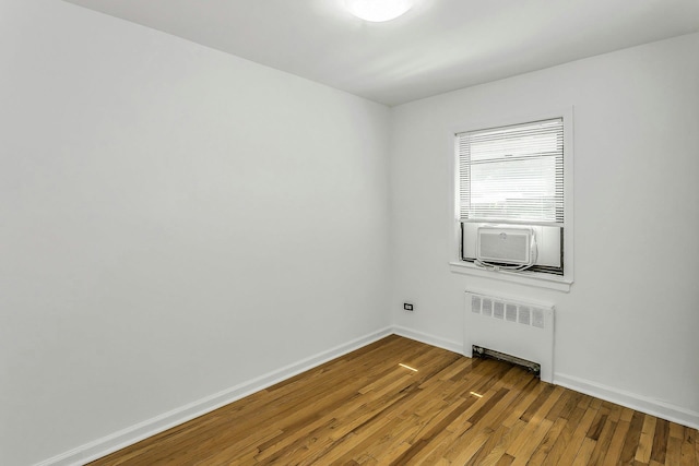 219-36 75th Ave Unit 243A2, Bayside, NY 11364 - unfurnished room featuring radiator, wood finished floors, baseboards, and cooling unit