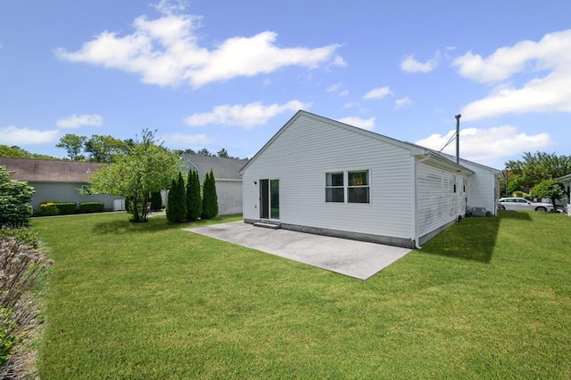 rear view of house featuring a patio and a lawn