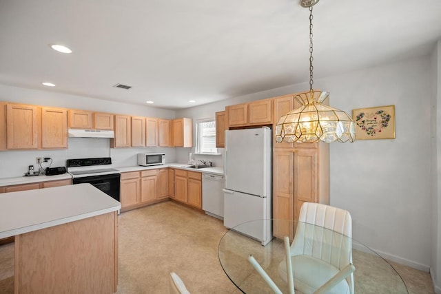 kitchen featuring white appliances, light brown cabinets, under cabinet range hood, light countertops, and recessed lighting