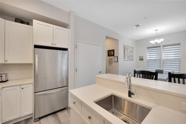 308 Breton Way Unit 308, Glen Cove, NY 11542 - kitchen with freestanding refrigerator, a sink, white cabinetry, and light countertops
