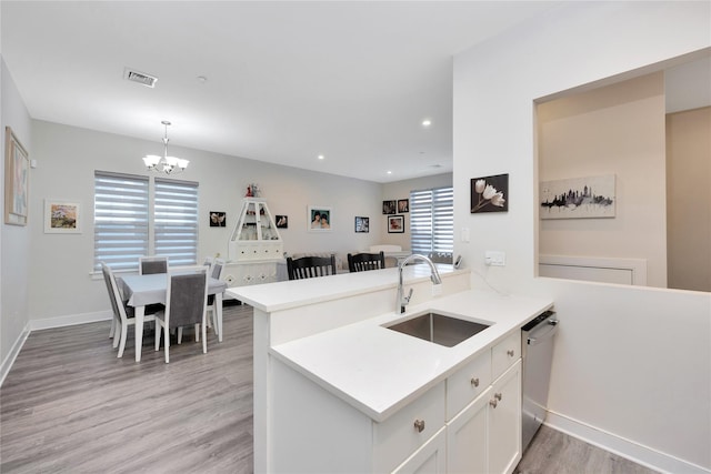 308 Breton Way Unit 308, Glen Cove, NY 11542 - kitchen with a sink, light wood finished floors, stainless steel dishwasher, a chandelier, and light countertops