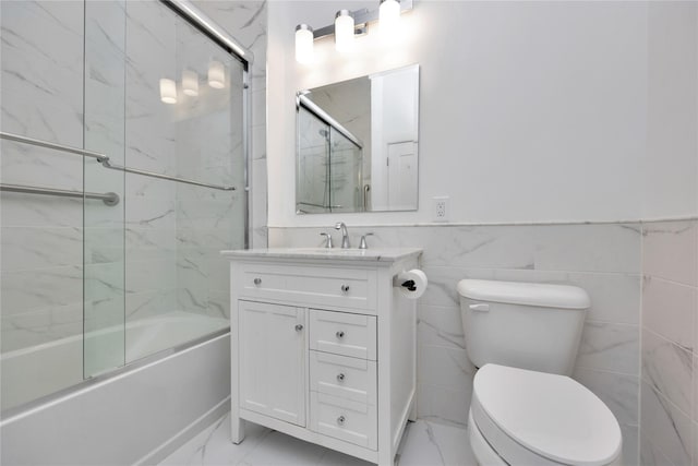 308 Breton Way Unit 308, Glen Cove, NY 11542 - bathroom featuring toilet, vanity, shower / bath combination with glass door, wainscoting, and tile walls