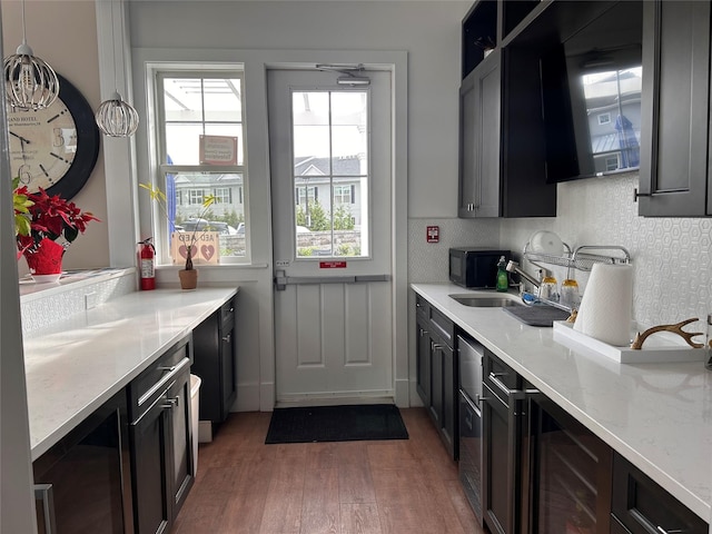 308 Breton Way Unit 308, Glen Cove, NY 11542 - kitchen featuring wood finished floors, healthy amount of natural light, black microwave, and beverage cooler