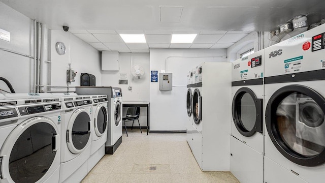 90 Knightsbridge Rd Unit H 1, Great Neck, NY 11021 - community laundry room with light flooring, separate washer and dryer, and baseboards