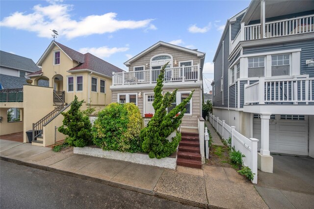 49 Oregon St, Long Beach, NY 11561 - view of front of home with stairs, a balcony, and an attached garage