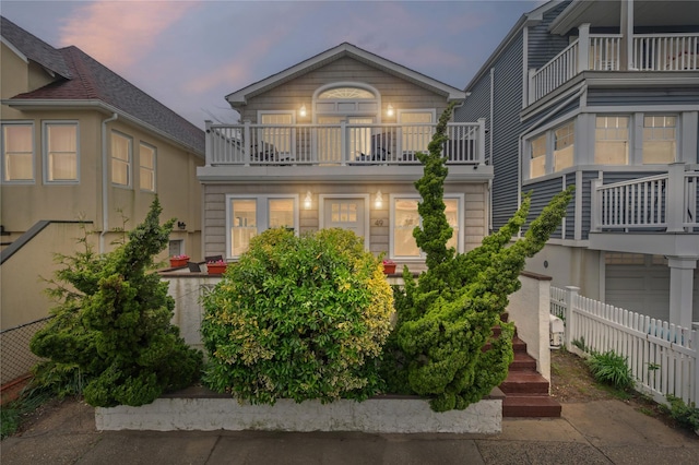 49 Oregon St, Long Beach, NY 11561 - rear view of property featuring a balcony, fence, and a garage