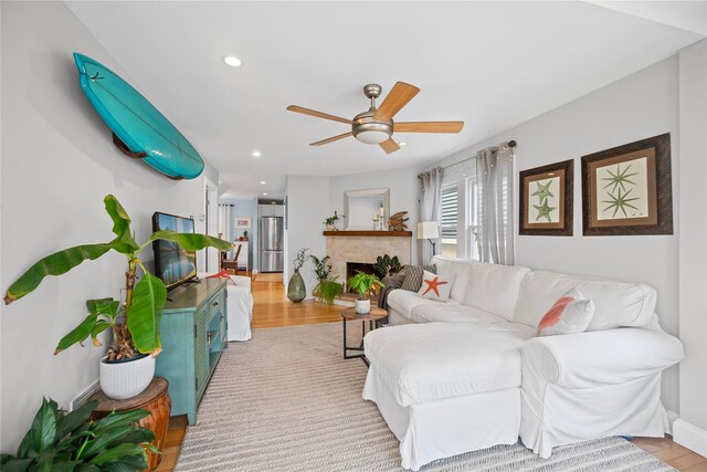 49 Oregon St, Long Beach, NY 11561 - living room featuring ceiling fan, recessed lighting, wood finished floors, and a brick fireplace