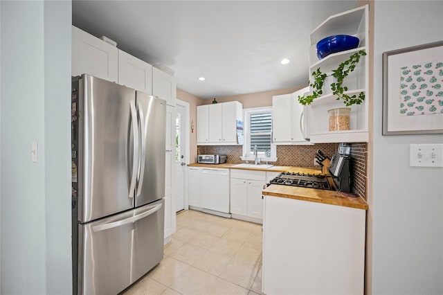 49 Oregon St, Long Beach, NY 11561 - kitchen with appliances with stainless steel finishes, open shelves, a sink, light tile patterned floors, and backsplash