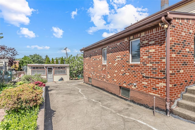 view of side of property featuring brick siding