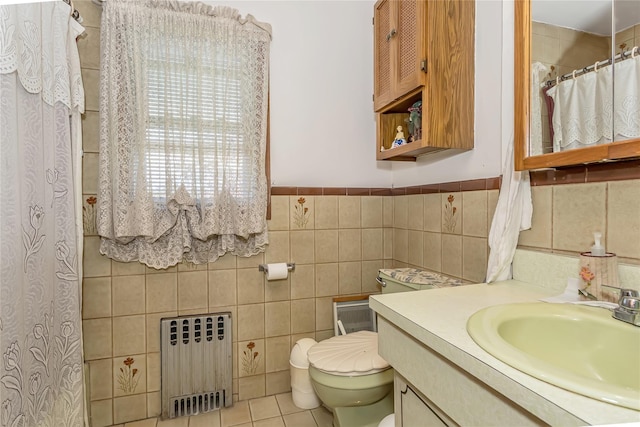 full bath featuring radiator heating unit, toilet, tile walls, vanity, and tile patterned flooring