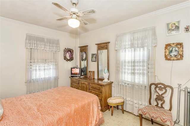 bedroom featuring crown molding, multiple windows, and ceiling fan