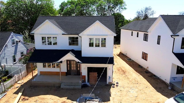 2660 Woods Ave, East Meadow, NY 11554 - modern farmhouse with board and batten siding, roof with shingles, fence, and french doors