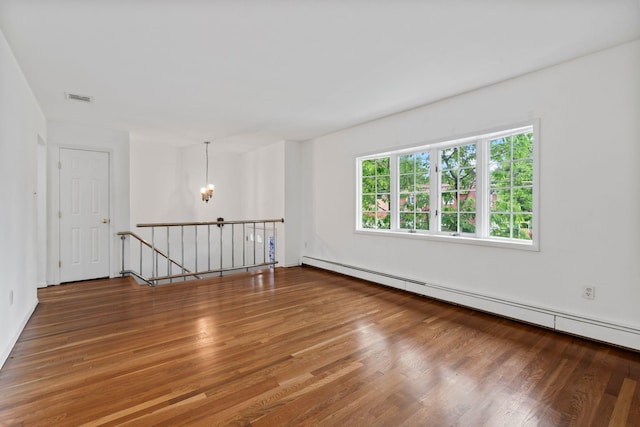 90 Cocks Ln, Locust Valley, NY 11560 - unfurnished room with a chandelier, wood finished floors, and a baseboard heating unit