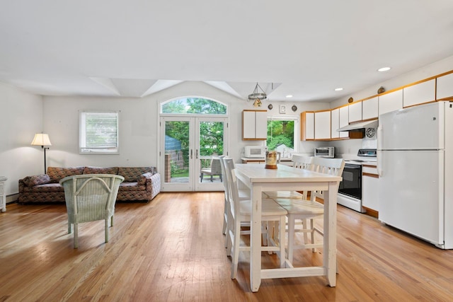 90 Cocks Ln, Locust Valley, NY 11560 - dining space featuring healthy amount of natural light, light wood-style flooring, french doors, and recessed lighting