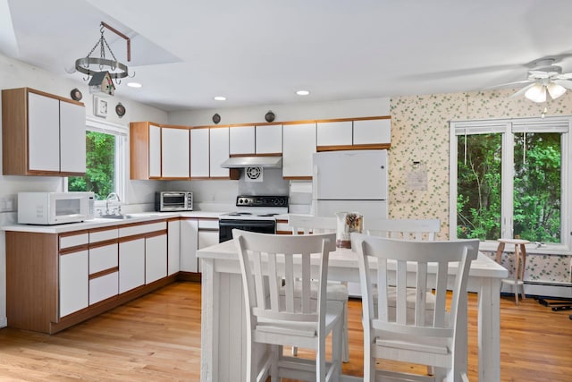 90 Cocks Ln, Locust Valley, NY 11560 - kitchen featuring white appliances, a sink, light wood-style floors, light countertops, and recessed lighting