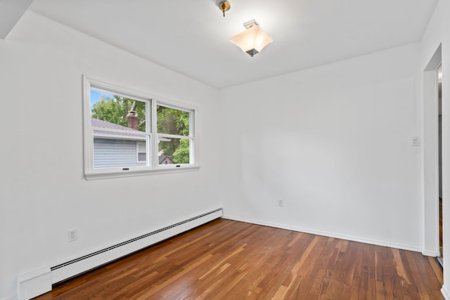 90 Cocks Ln, Locust Valley, NY 11560 - unfurnished room with a baseboard heating unit, wood finished floors, and baseboards