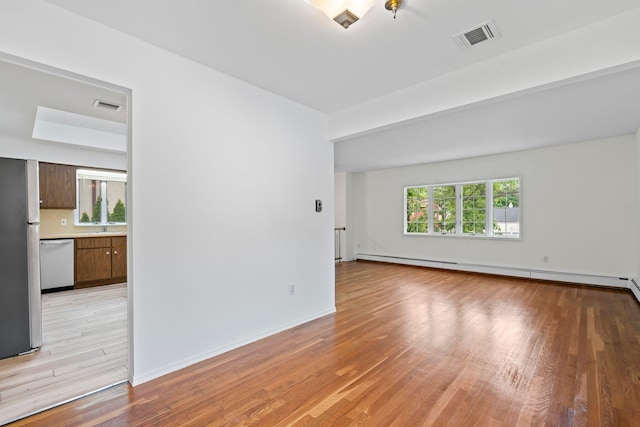 90 Cocks Ln, Locust Valley, NY 11560 - unfurnished room featuring light wood-style floors, a baseboard radiator, and baseboards