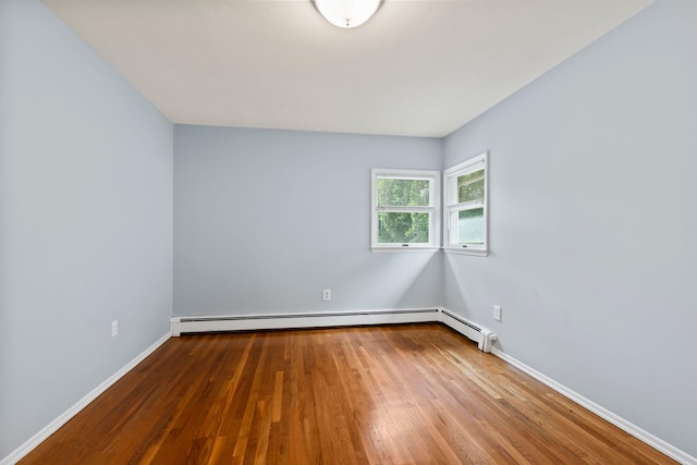 90 Cocks Ln, Locust Valley, NY 11560 - empty room with wood finished floors, baseboards, and a baseboard heating unit
