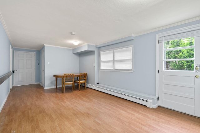 90 Cocks Ln, Locust Valley, NY 11560 - unfurnished dining area featuring a baseboard radiator, ornamental molding, light wood-style flooring, and baseboards