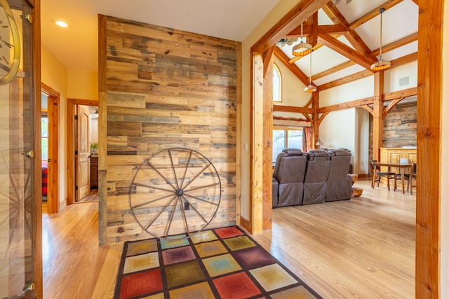 entryway with wood finished floors and wood walls