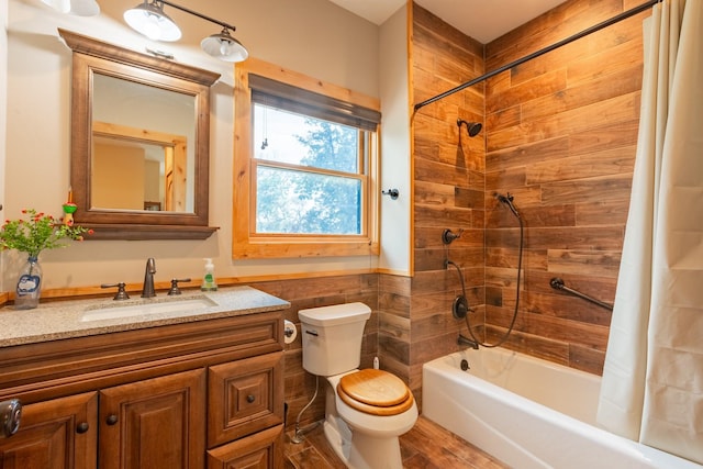 bathroom with toilet, shower / tub combo, vanity, tile walls, and wood finished floors