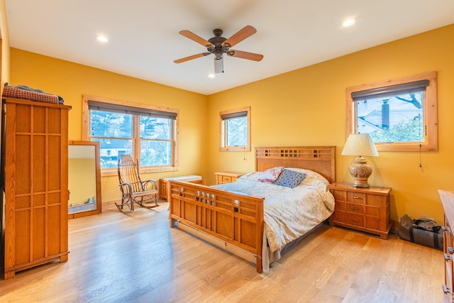 bedroom featuring light wood finished floors, recessed lighting, and baseboards