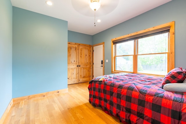 bedroom with light wood finished floors, baseboards, recessed lighting, and a ceiling fan