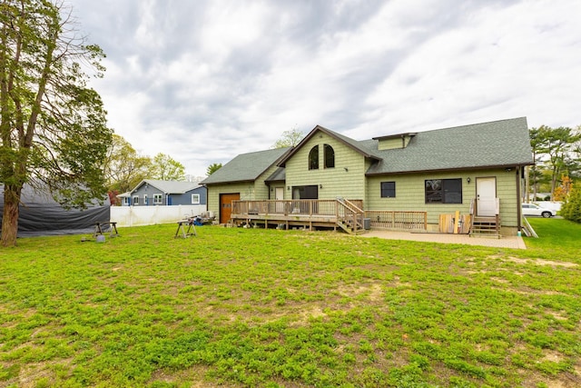 back of property featuring a wooden deck, entry steps, and roof with shingles