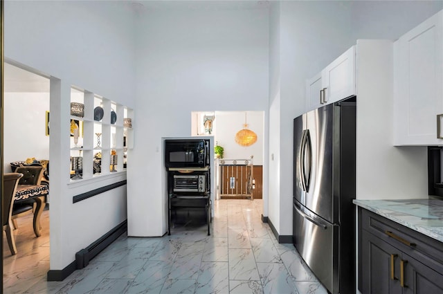 2A Belmont Ave Unit A, Plainview, NY 11803 - kitchen featuring freestanding refrigerator, light marble finish floors, a towering ceiling, black microwave, and light stone counters