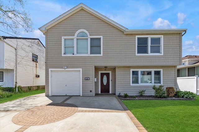 view of front of house with concrete driveway, a front yard, and an attached garage