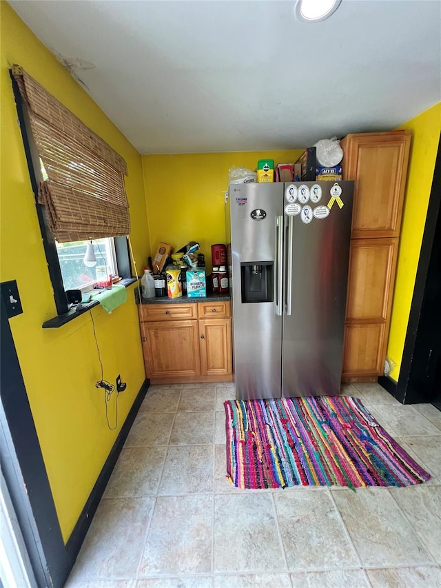 24 Rte 217, Hudson, NY 12534 - kitchen featuring stainless steel refrigerator with ice dispenser, brown cabinets, and light stone finish flooring