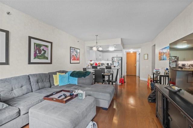 50 E Hartsdale Ave Unit 3S, Hartsdale, NY 10530 - living room with dark wood-style floors, a chandelier, and baseboards
