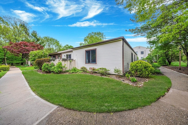view of side of home with a lawn