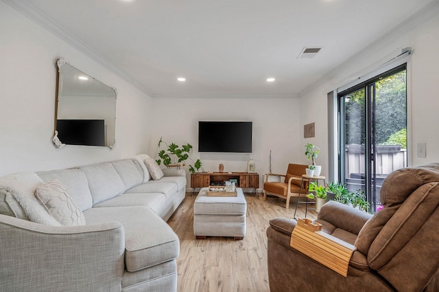 living area with ornamental molding, light wood finished floors, and recessed lighting