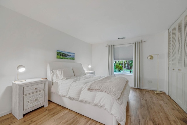 bedroom featuring light wood-style floors and baseboards