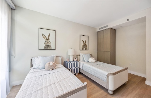 bedroom with baseboards and light wood-style floors