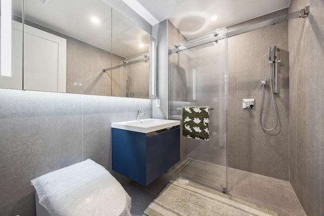 bathroom featuring a tile shower and vanity