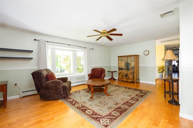 33 Roberts Rd, Wappingers Falls, NY 12590 - living room with a baseboard radiator, a baseboard heating unit, light wood-style flooring, a ceiling fan, and baseboards