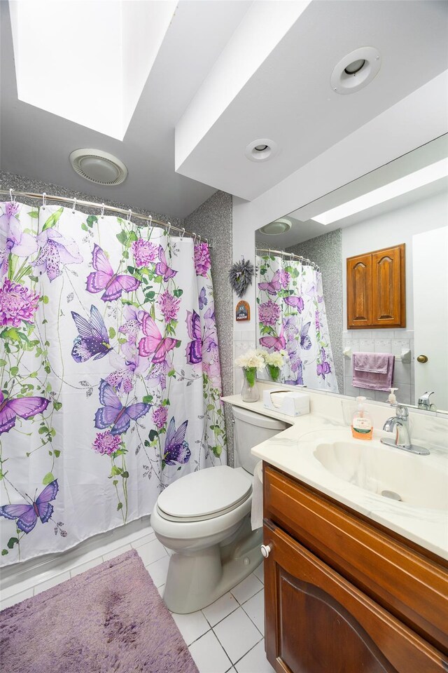 33 Roberts Rd, Wappingers Falls, NY 12590 - full bath featuring tile patterned flooring, toilet, vanity, a skylight, and a shower with shower curtain
