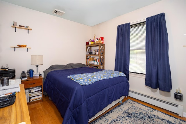 33 Roberts Rd, Wappingers Falls, NY 12590 - bedroom with a baseboard heating unit and wood finished floors