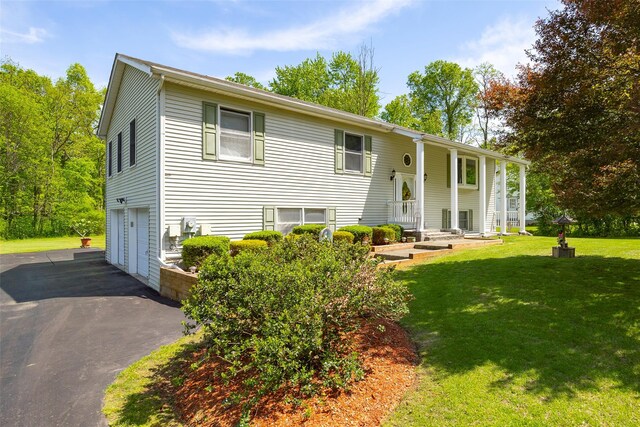 33 Roberts Rd, Wappingers Falls, NY 12590 - bi-level home with a garage, asphalt driveway, and a front yard
