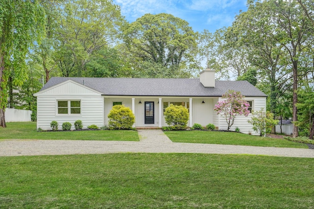 3 Thomas Dr, Wading River, NY 11792 - view of front of home with a front lawn, a chimney, and roof with shingles
