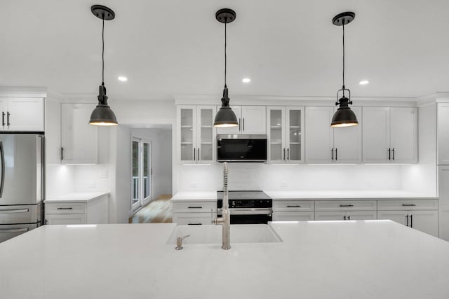 3 Thomas Dr, Wading River, NY 11792 - kitchen with stainless steel appliances, a sink, recessed lighting, light countertops, and white cabinetry