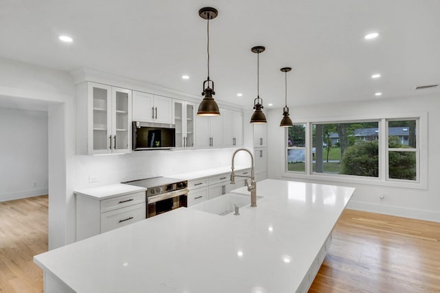 3 Thomas Dr, Wading River, NY 11792 - kitchen featuring stainless steel appliances, baseboards, a sink, a spacious island, and recessed lighting
